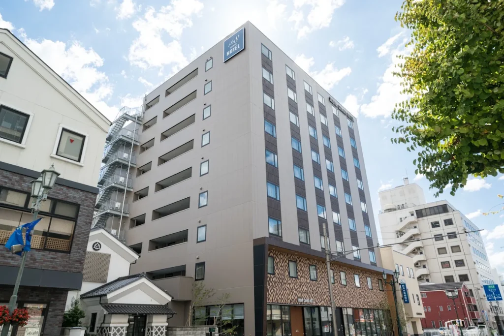 Exterior of Iroha Grand Hotel Matsumoto Station, a modern hotel located within walking distance of Matsumoto Station in Nagano, Japan.