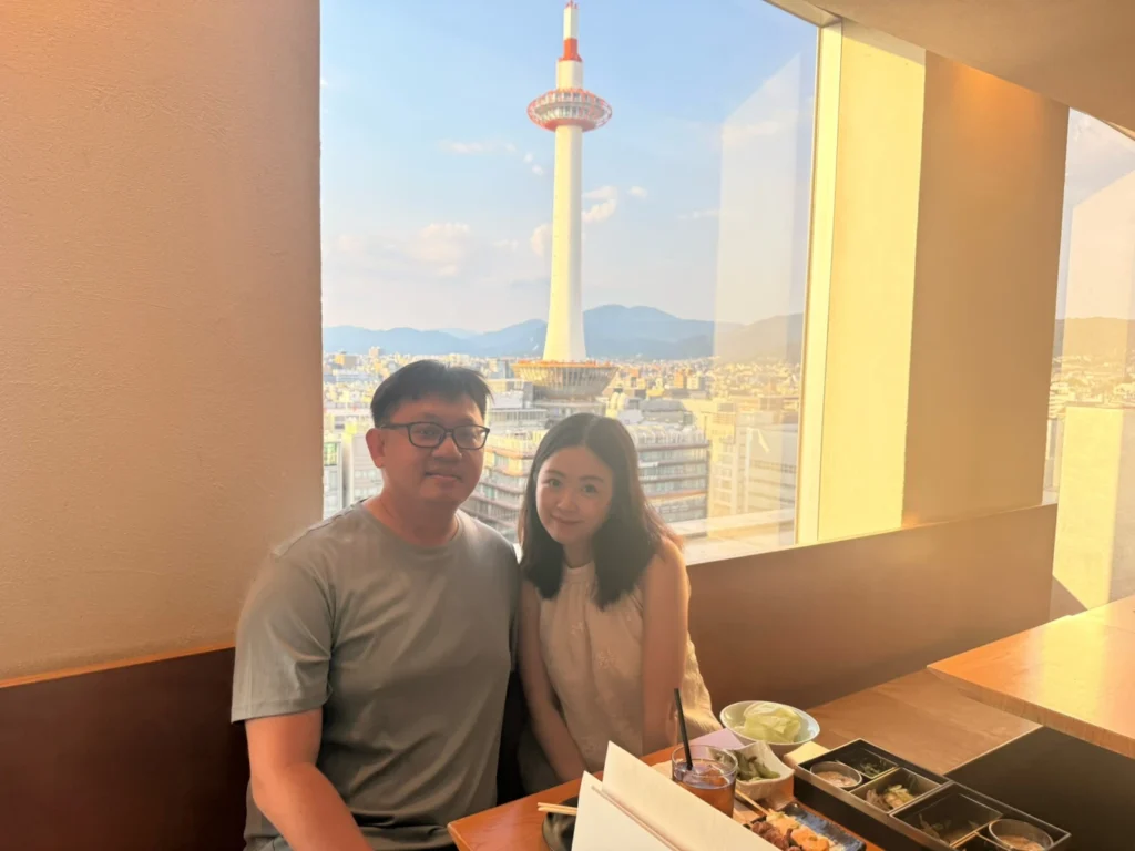 7-Day Osaka, Kyoto and Kobe Itinerary: Food, Shopping and Summer Sights 20 Couple dining beside a large window with a clear view of Kyoto Tower at Koke-kokko in Kyoto Station.