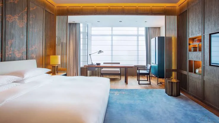 Modern guest room at Park Hyatt Hangzhou with floor-to-ceiling windows and contemporary design