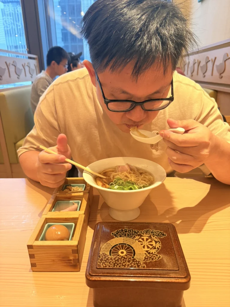Enjoying a bowl of signature duck ramen at Ramen Kamo to Negi Osaka Umeda