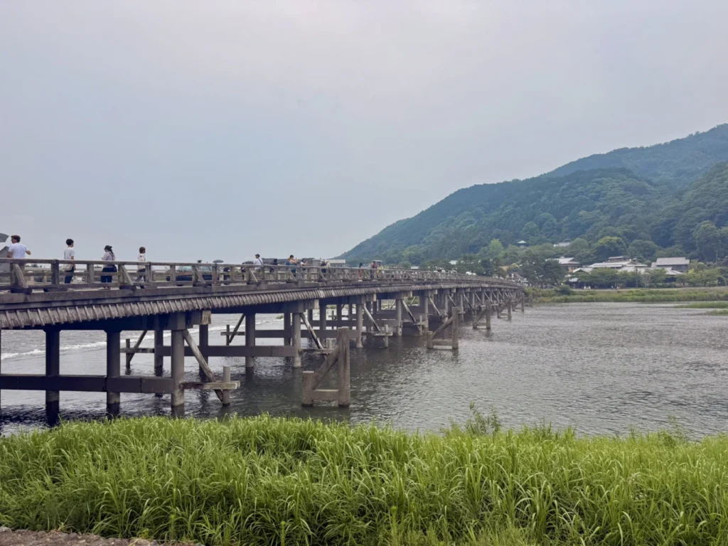 7-Day Osaka, Kyoto and Kobe Itinerary: Food, Shopping and Summer Sights 34 Togetsukyo Bridge crossing the Katsura River with green mountains in Arashiyama, Kyoto.