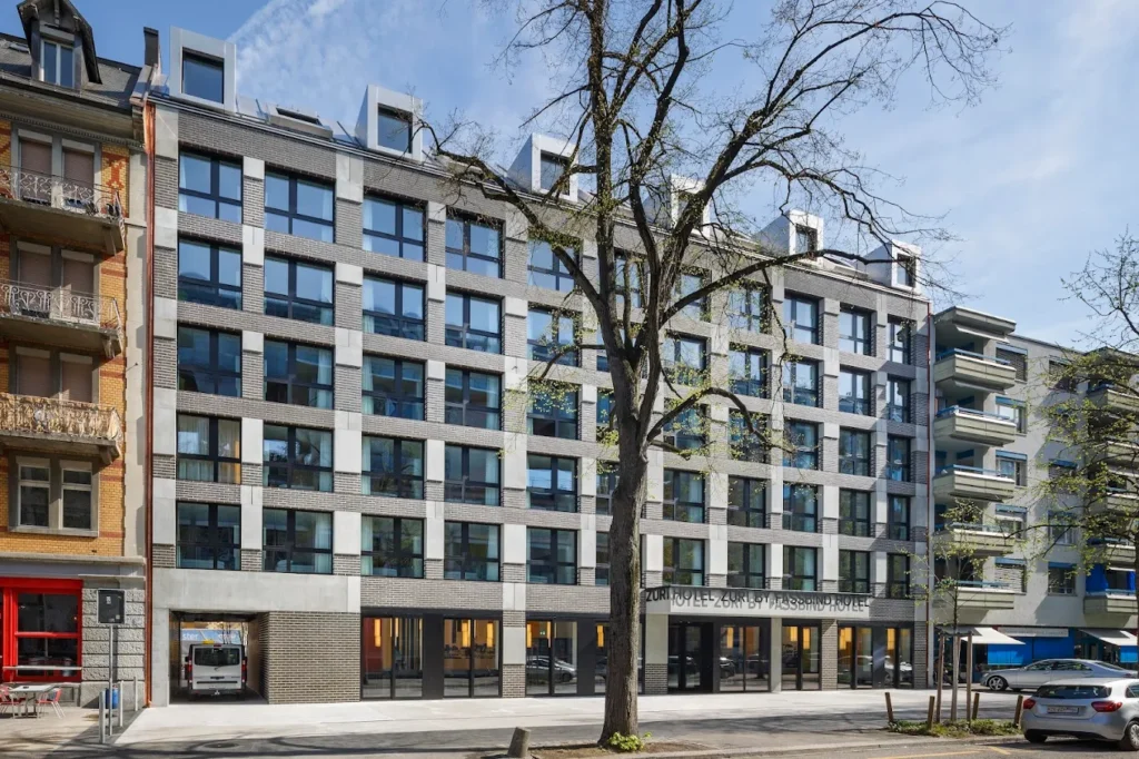Exterior view of Züri by Fassbind, a modern family-friendly hotel in Zurich offering spacious rooms and convenient tram access to the city centre and Zurich Main Station.