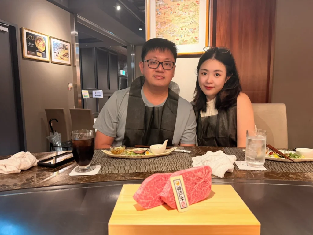 7-Day Osaka, Kyoto and Kobe Itinerary: Food, Shopping and Summer Sights 8 Couple seated at Ishida Kobe Beef in Osaka with premium marbled Kobe beef ready for teppanyaki cooking.