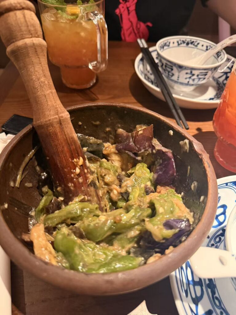 Nong Geng Ji Jewel Review: Family-Friendly Hunan Food at Changi Airport 9 Pan-seared green chillies and century egg served in a clay bowl with a wooden pestle