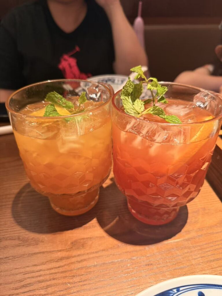 Nong Geng Ji Jewel Review: Family-Friendly Hunan Food at Changi Airport 10 Orange and pink fruit teas topped with mint at Nong Geng Ji Jewel
