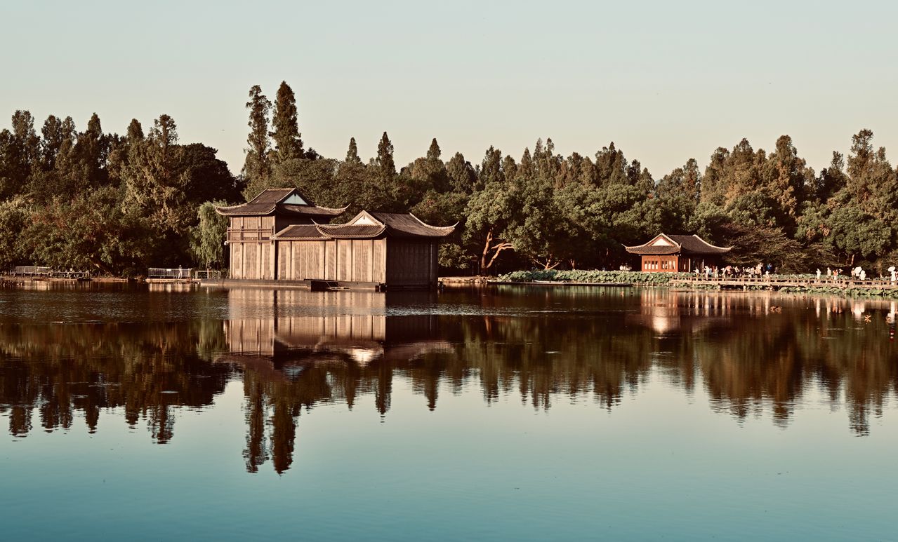 Traditional pavilion reflected on the calm waters of West Lake in Hangzhou, China