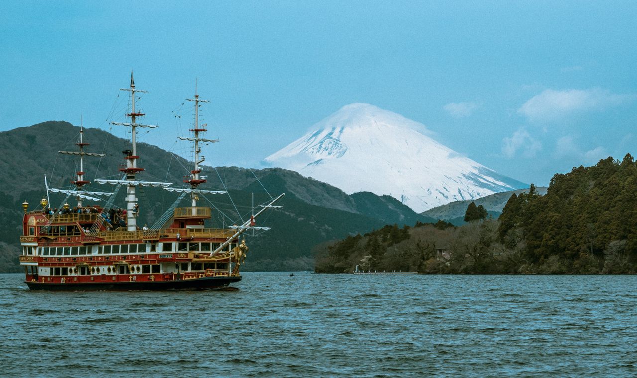 Hakone sightseeing pirate ship cruising across Lake Ashi with snow-capped Mount Fuji in the background on a clear day.