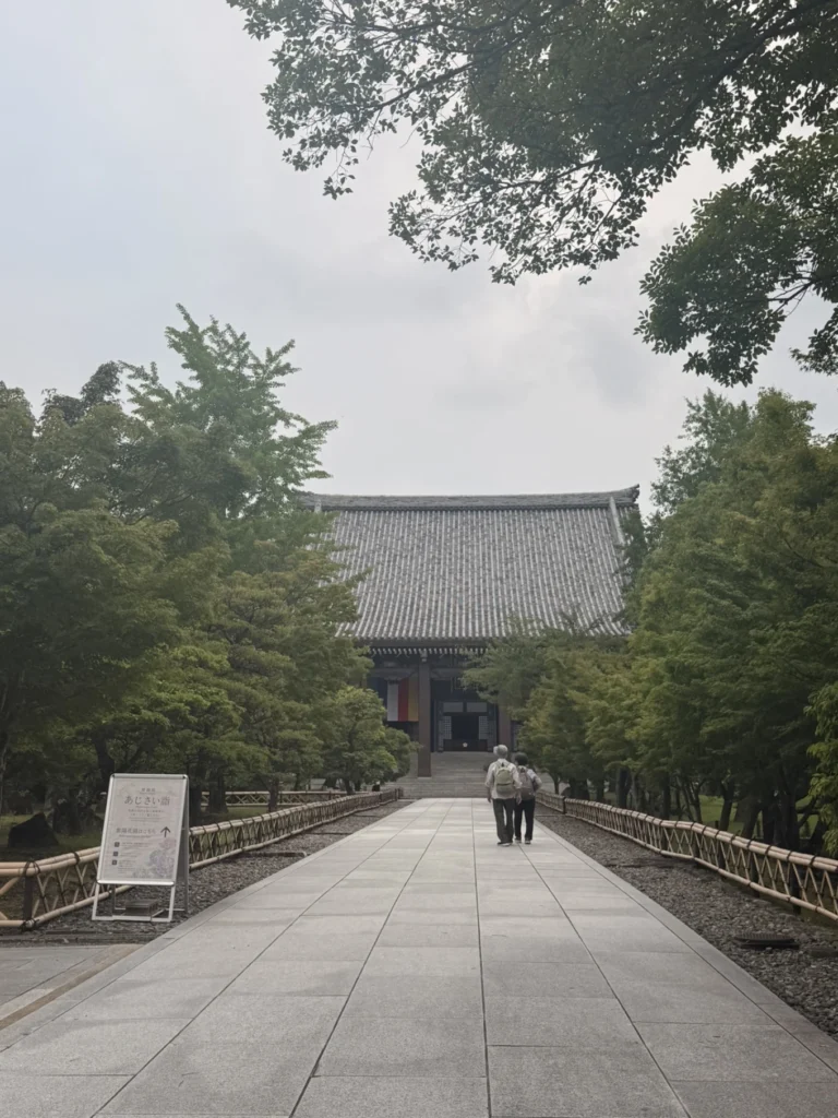 Stone approach leading to Chishaku-in Temple surrounded by trees in Kyoto