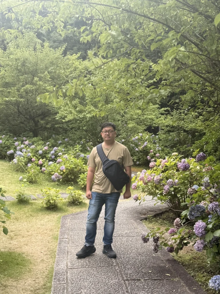 Visitor standing among hydrangeas in the Chishaku-in garden in Kyoto
