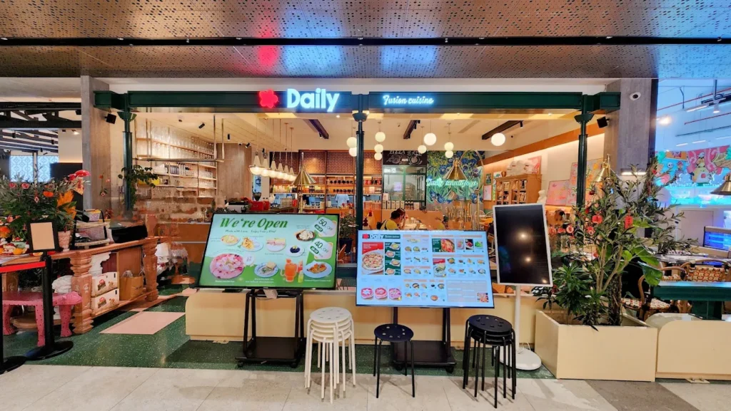 Lentor Modern Food Guide: 17 Best Places To Eat Near Lentor MRT 18 Daily fusion restaurant storefront at Lentor Modern, featuring colourful décor, menu displays and open casual seating.
