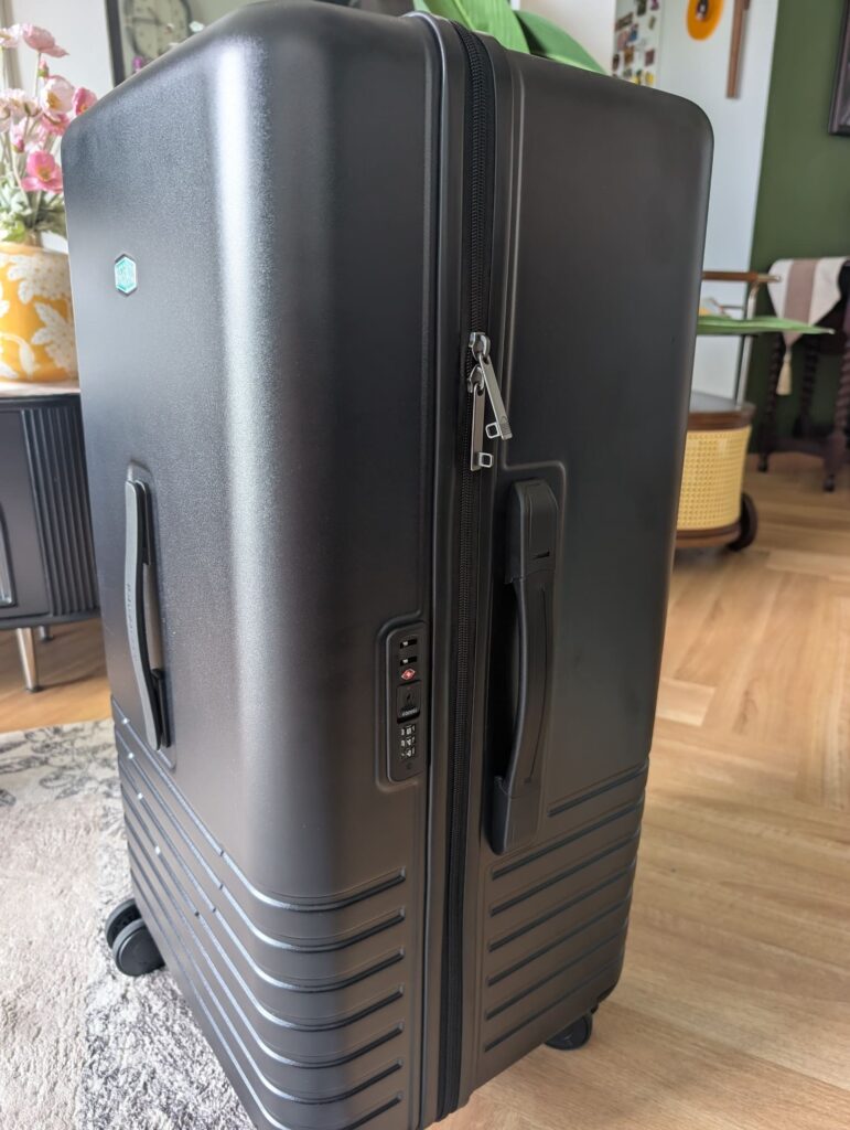 Bagsmart Getaway 30 Trunk Review: A Hands-On First Look at This 96L Checked Luggage 8 Side view of Bagsmart Getaway 30 Trunk showing TSA lock and carry handle