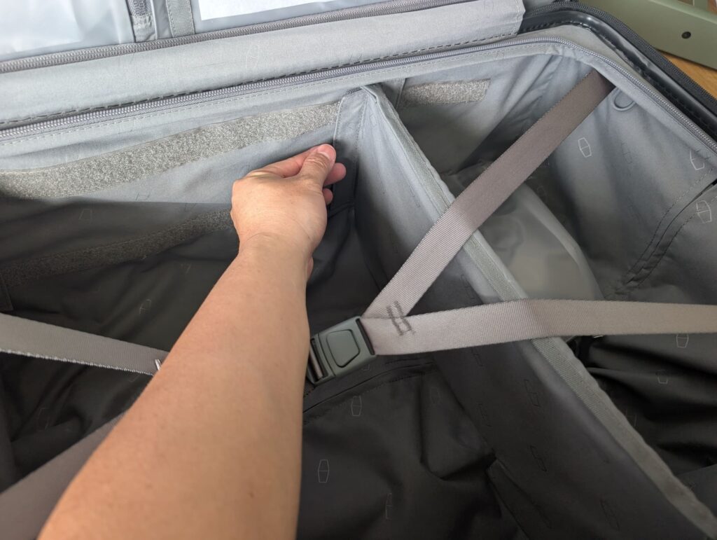 Bagsmart Getaway 30 Trunk Review: A Hands-On First Look at This 96L Checked Luggage 12 Adjustable divider being repositioned inside Bagsmart Getaway 30 Trunk