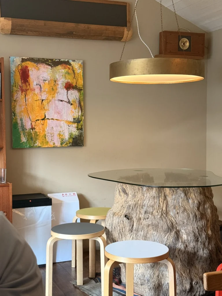 Nakazakicho Osaka City Walk: Exploring Osaka's Retro Neighbourhood 12 Rustic tree trunk table and artwork inside neel Nakazakicho cafe