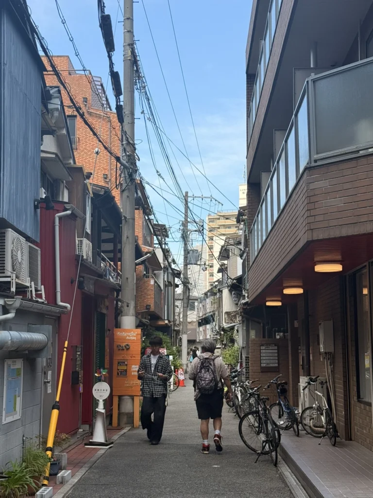 Nakazakicho Osaka City Walk: Exploring Osaka's Retro Neighbourhood 3 People walking along a narrow lane with bicycles and shops in Nakazakicho Osaka