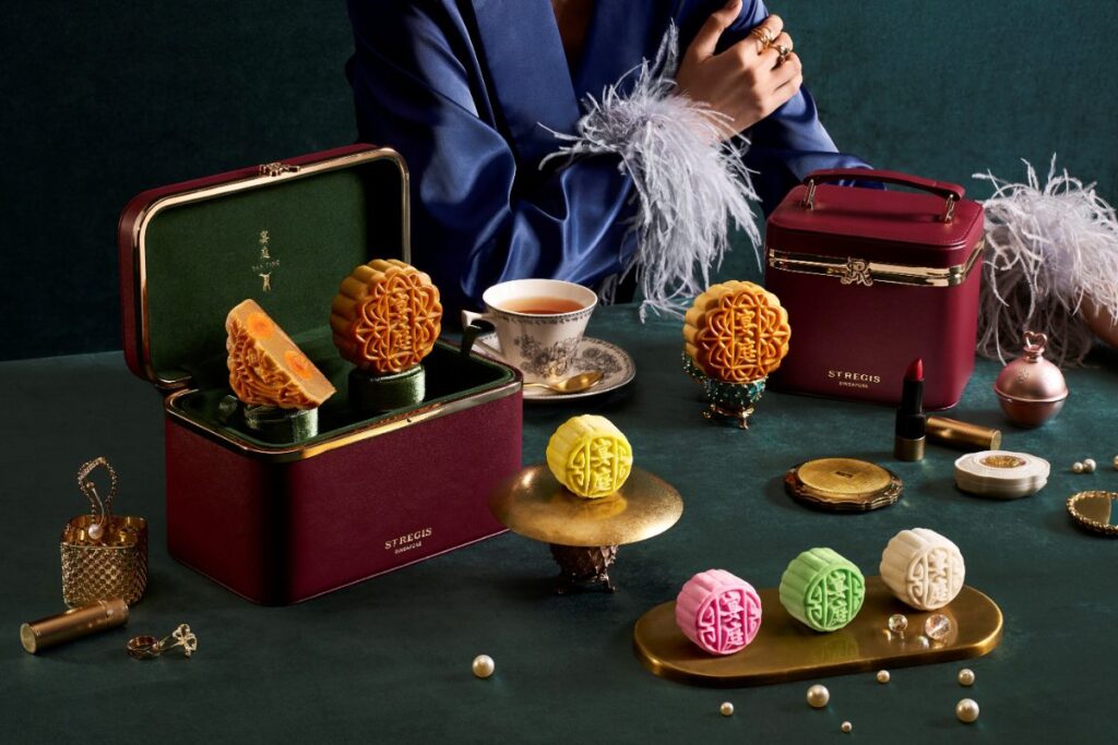 The St. Regis Singapore baked and colourful snowskin mooncakes with burgundy luxury gift cases for Mid-Autumn Festival 2026