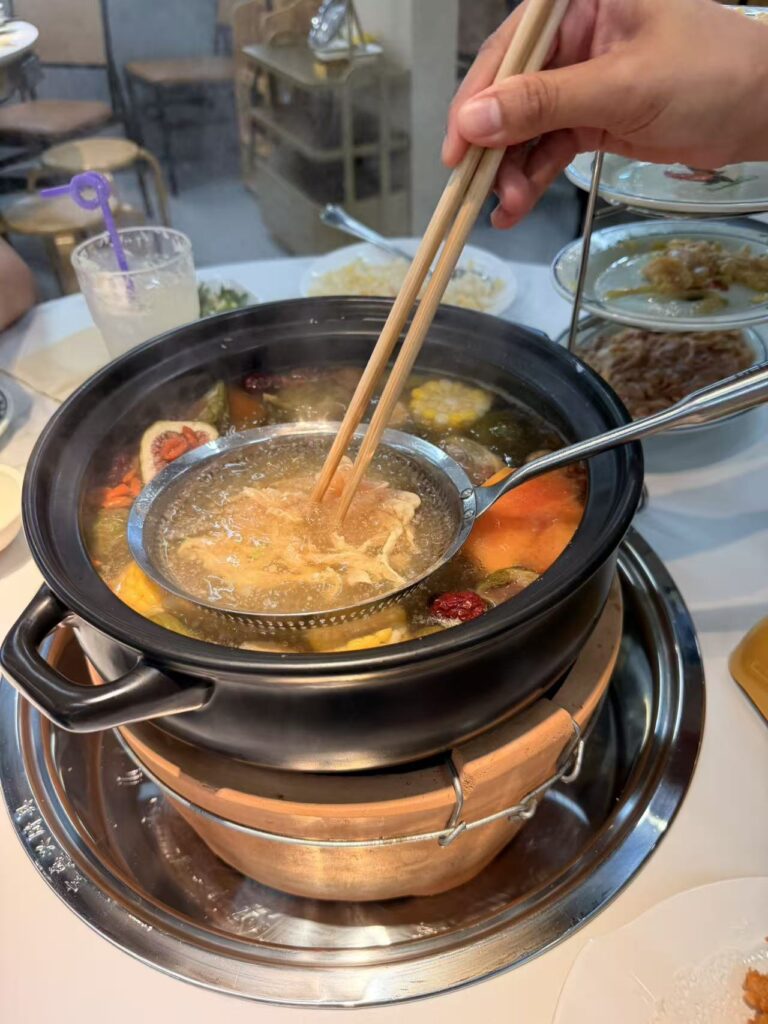Chao Baba Freshly Cut Chicken Pot Review at SAFRA Punggol 8 Fresh chicken being cooked in a bubbling fig chicken soup pot at Chao Baba.