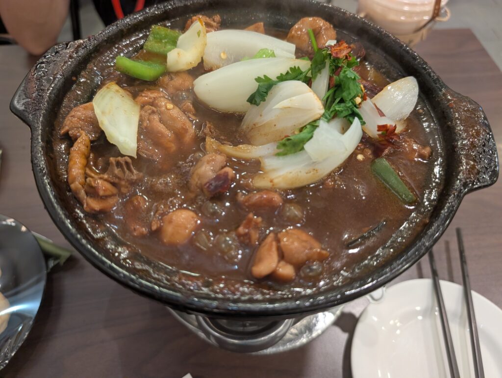 Large spicy Chicken Hotpot with chicken, onions and vegetables at Compass One Singapore