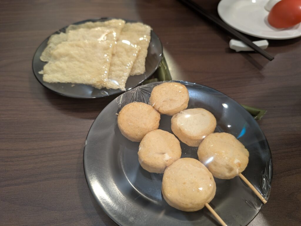 Hotpot add-on ingredients including fish balls and fried beancurd skin at Chicken Hotpot Compass One