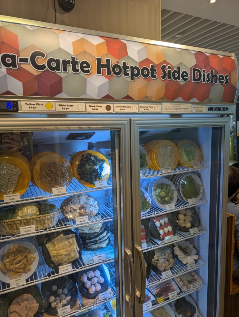 Self-service hotpot side dishes and plate prices at Chicken Hotpot Compass One