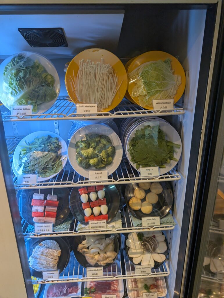 Vegetables, enoki mushrooms, cheese tofu and other hotpot ingredients at Chicken Hotpot Compass One